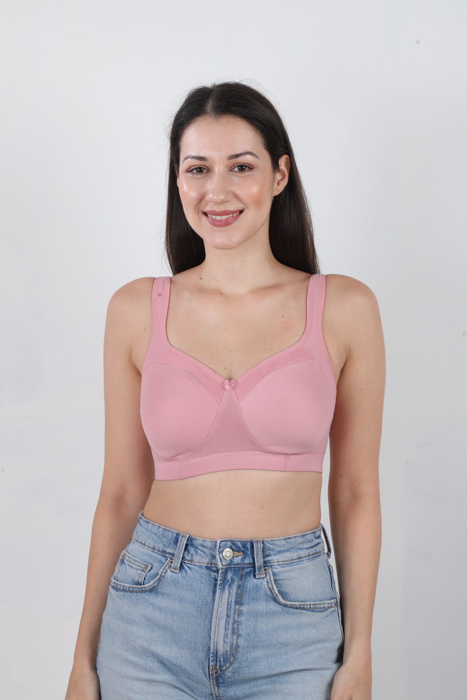 Front view of woman demonstrating easy drop cup feeding clasp on Casurina pink cotton maternity bra